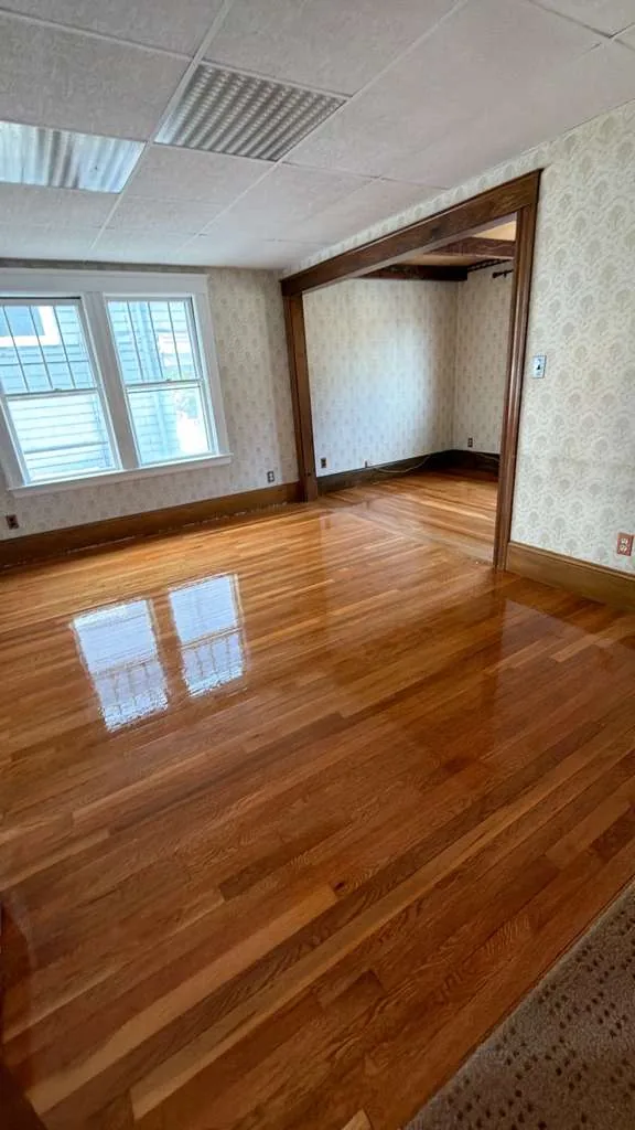 Refinished hardwood room with natural light